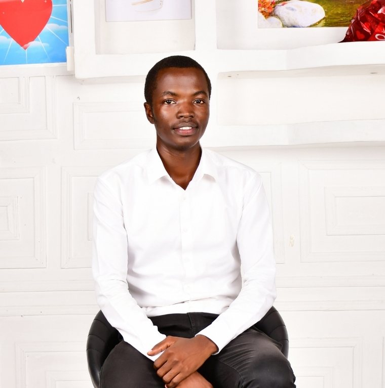Alex Were seated in a bright studio